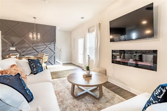 a living room with furniture and a flat screen tv