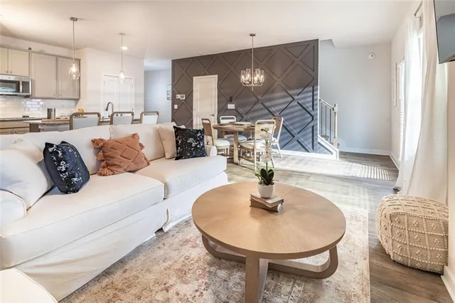 a living room with furniture and a dining table