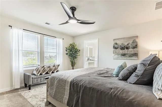 a bedroom with a large bed and a large window
