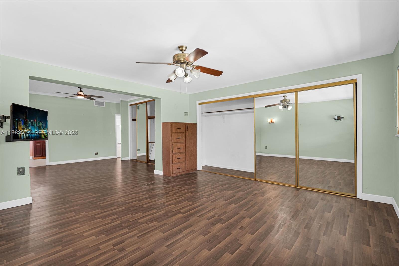 4560 Prairie Avenue Miami Beach, FL 33140 - Photo 6 of 15 a view of a livingroom with wooden floor and a ceiling fan