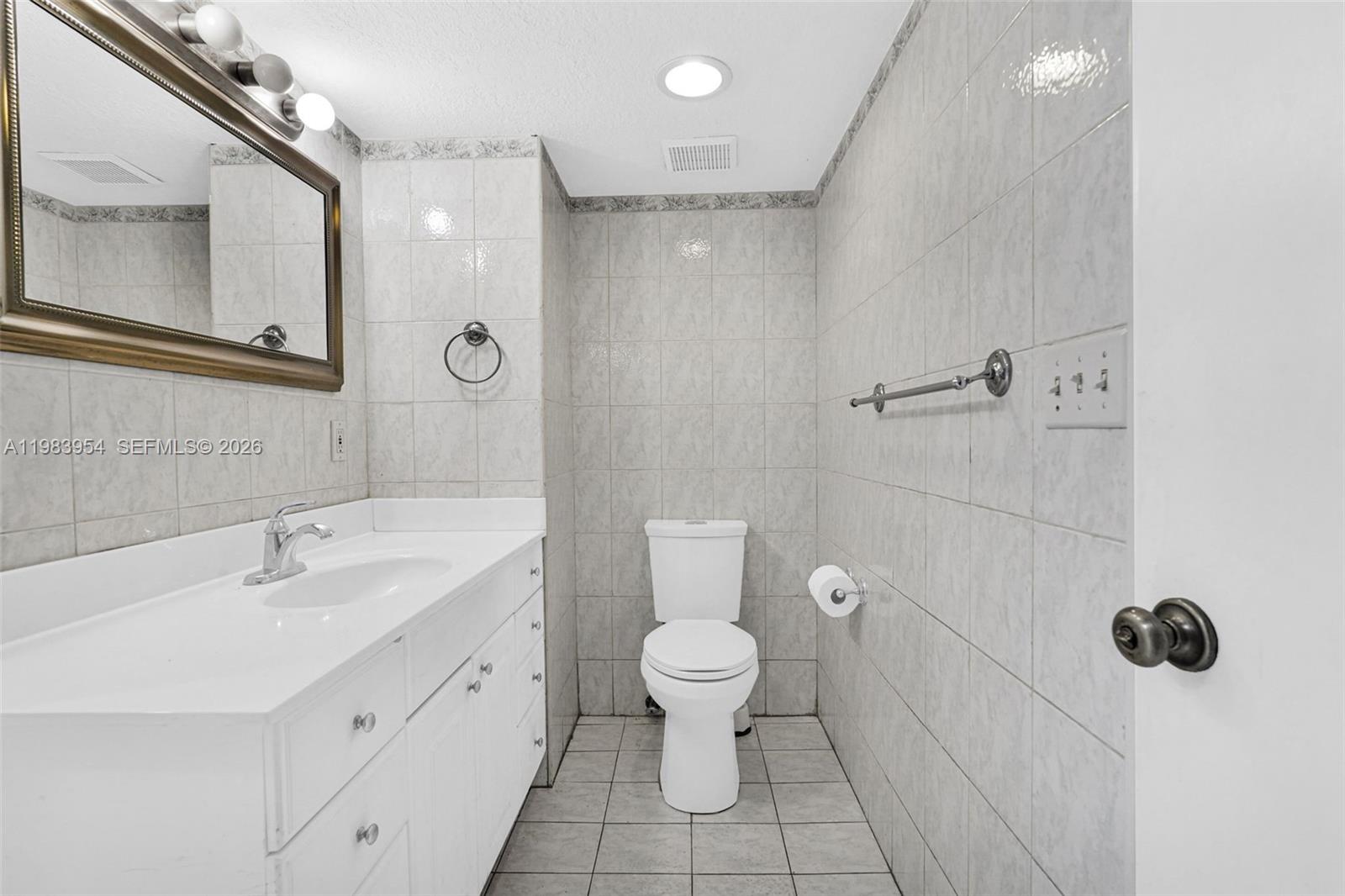 4560 Prairie Avenue Miami Beach, FL 33140 - Photo 10 of 15 a bathroom with a toilet sink and shower