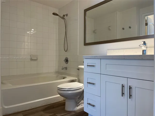 a bathroom with a toilet a sink and bathtub