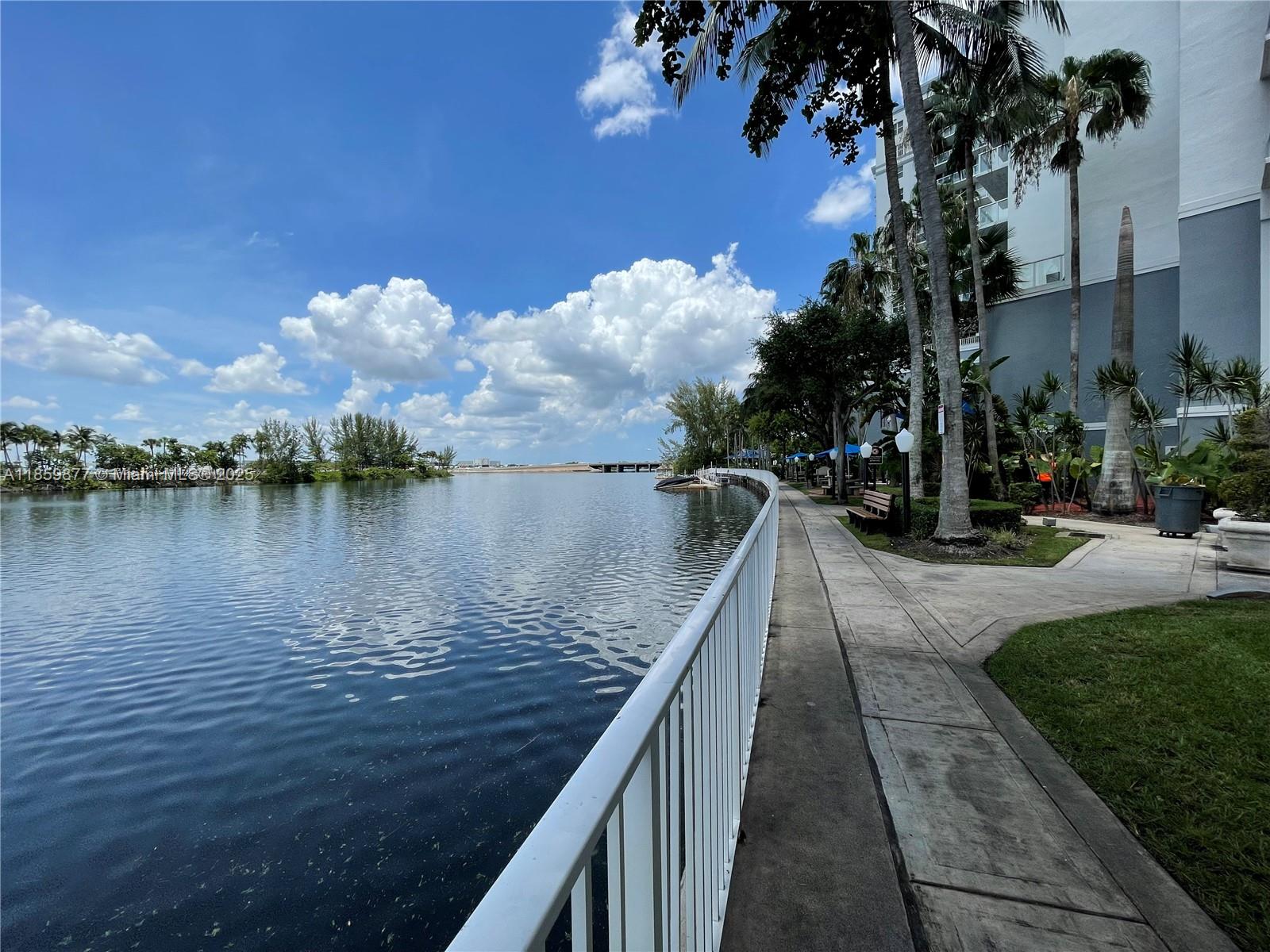 5085 Northwest 7th Street, Unit 1203 Miami, FL 33126 - Photo 25 of 26 a view of a lake with a floor to ceiling window next to a building