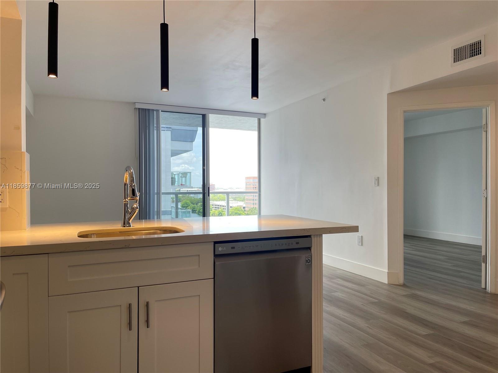 5085 Northwest 7th Street, Unit 1203 Miami, FL 33126 - Photo 6 of 26 a kitchen with a sink and a window