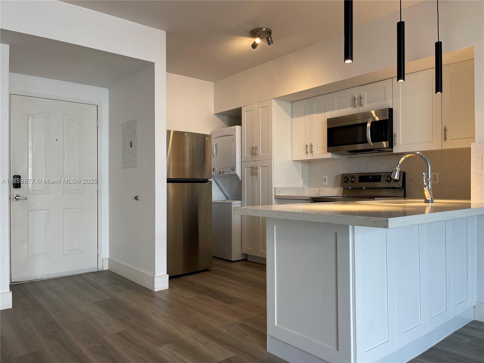 5085 Northwest 7th Street, Unit 1203 Miami, FL 33126 - Photo 10 of 26 a kitchen with a refrigerator and a sink