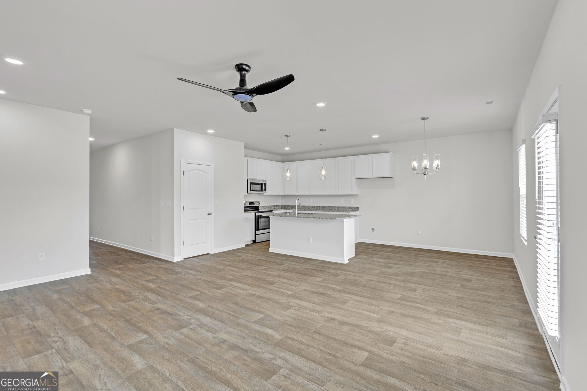 506 Holsteiner Road, Unit 64 Hogansville, GA 30230 - Photo 6 of 21 a view of an empty room with wooden floor and a window