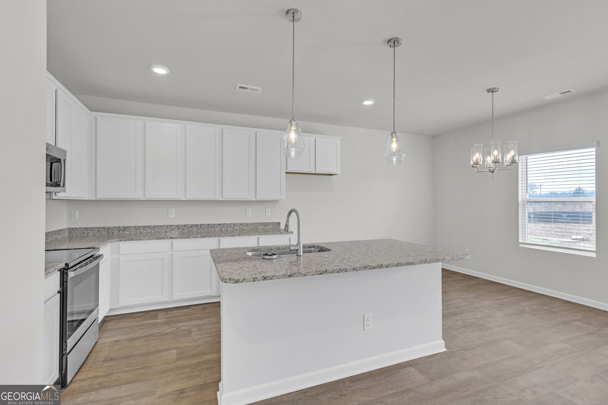 506 Holsteiner Road, Unit 64 Hogansville, GA 30230 - Photo 9 of 21 a kitchen with a sink window and cabinets