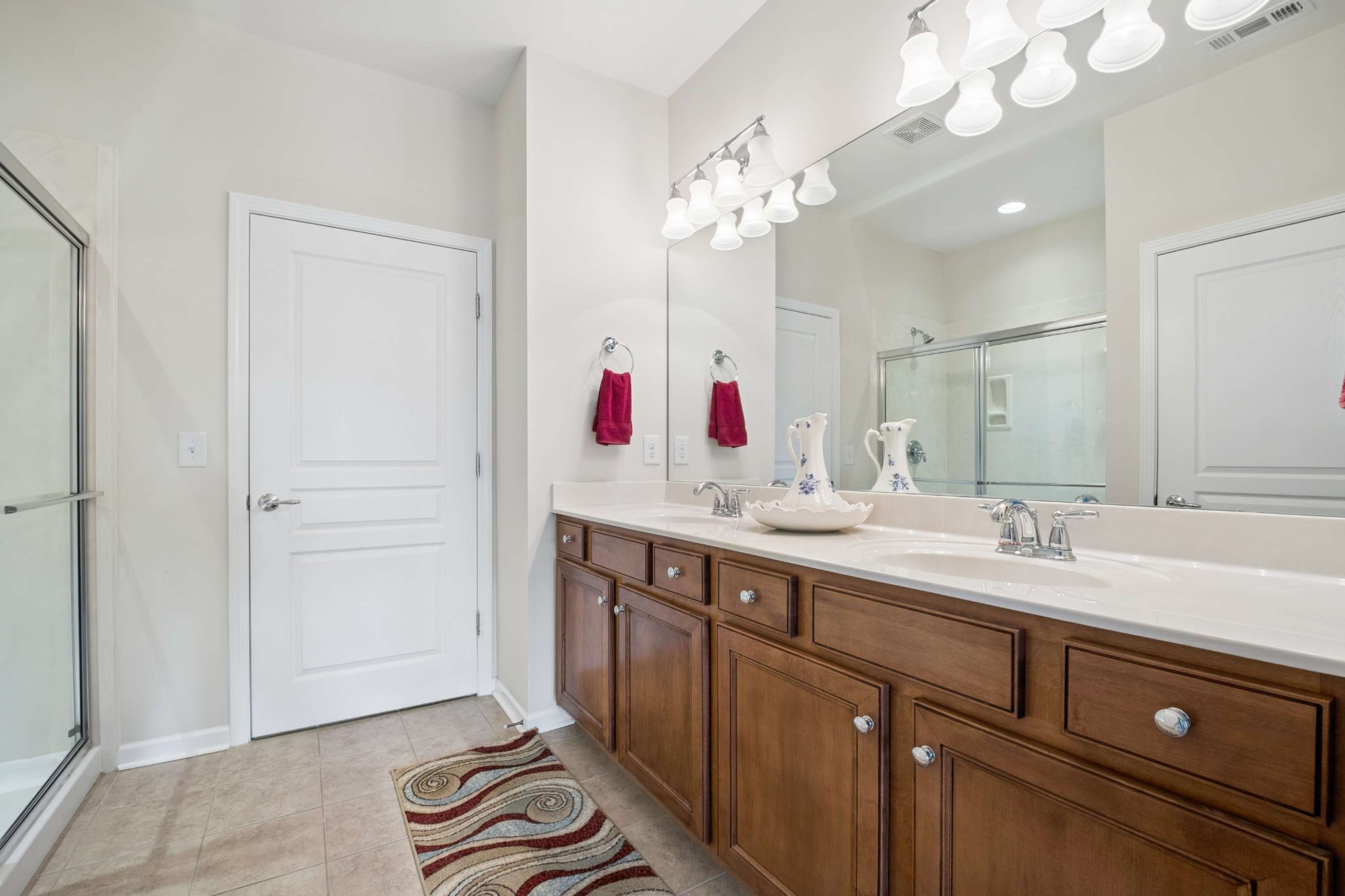 300 Blockade Lane Mount Juliet, TN 37122 - Photo 24 of 36 a spacious bathroom with a sink a large mirror and a shower