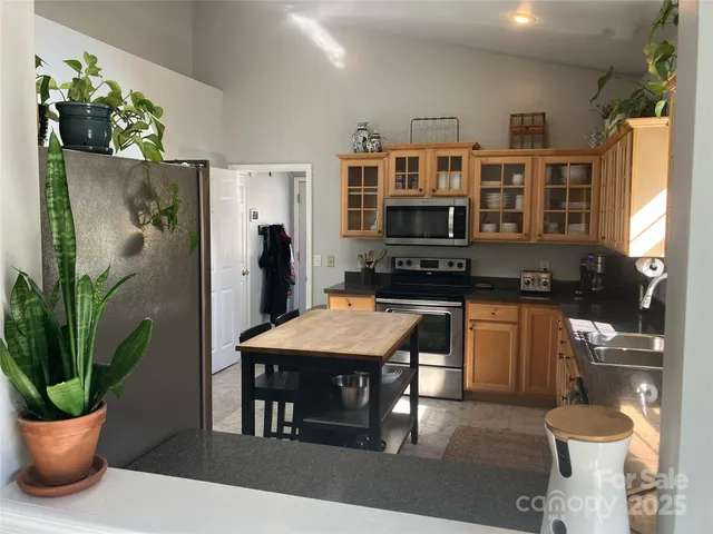 a kitchen with a table and chairs in it