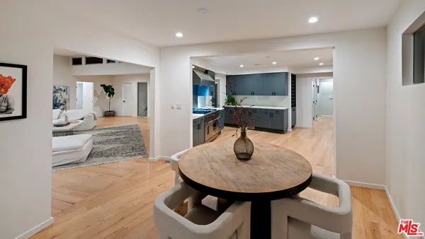 a living room with patio furniture and a flat screen tv