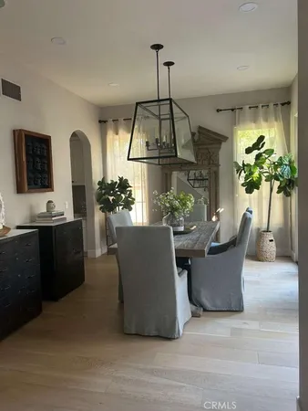 a dining room with furniture and a chandelier