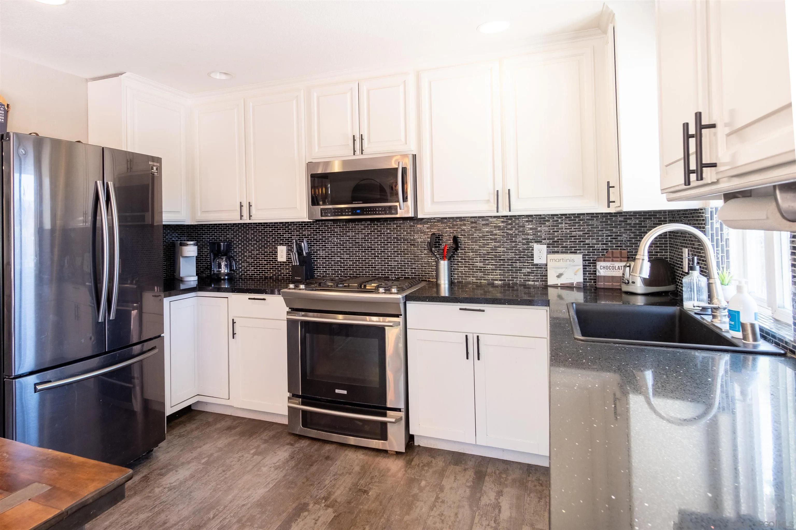 853 Crescent Drive Vista, CA 92084 - Photo 13 of 70 a kitchen with granite countertop a refrigerator stove and sink