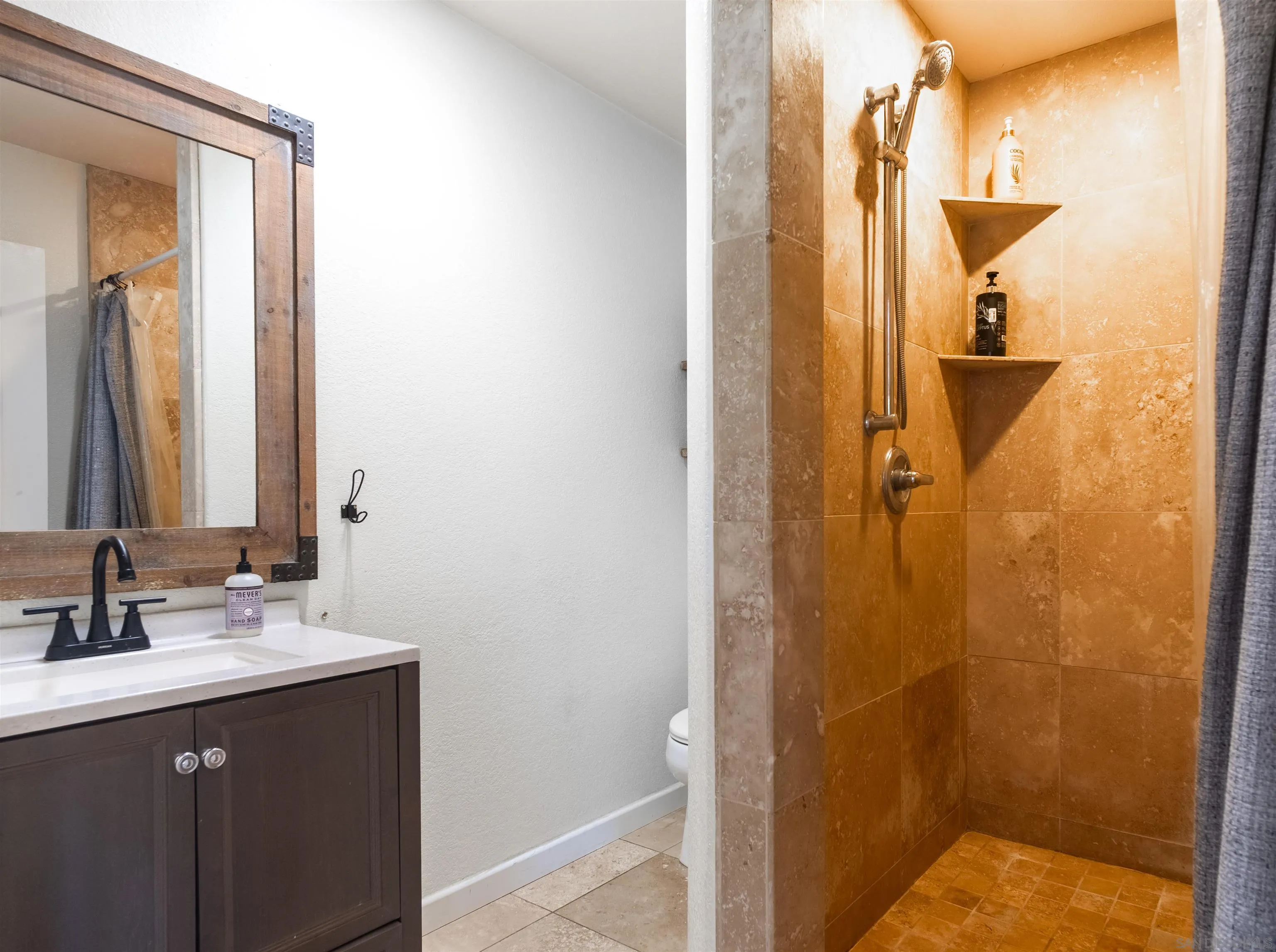 853 Crescent Drive Vista, CA 92084 - Photo 29 of 70 a bathroom with a sink and mirror