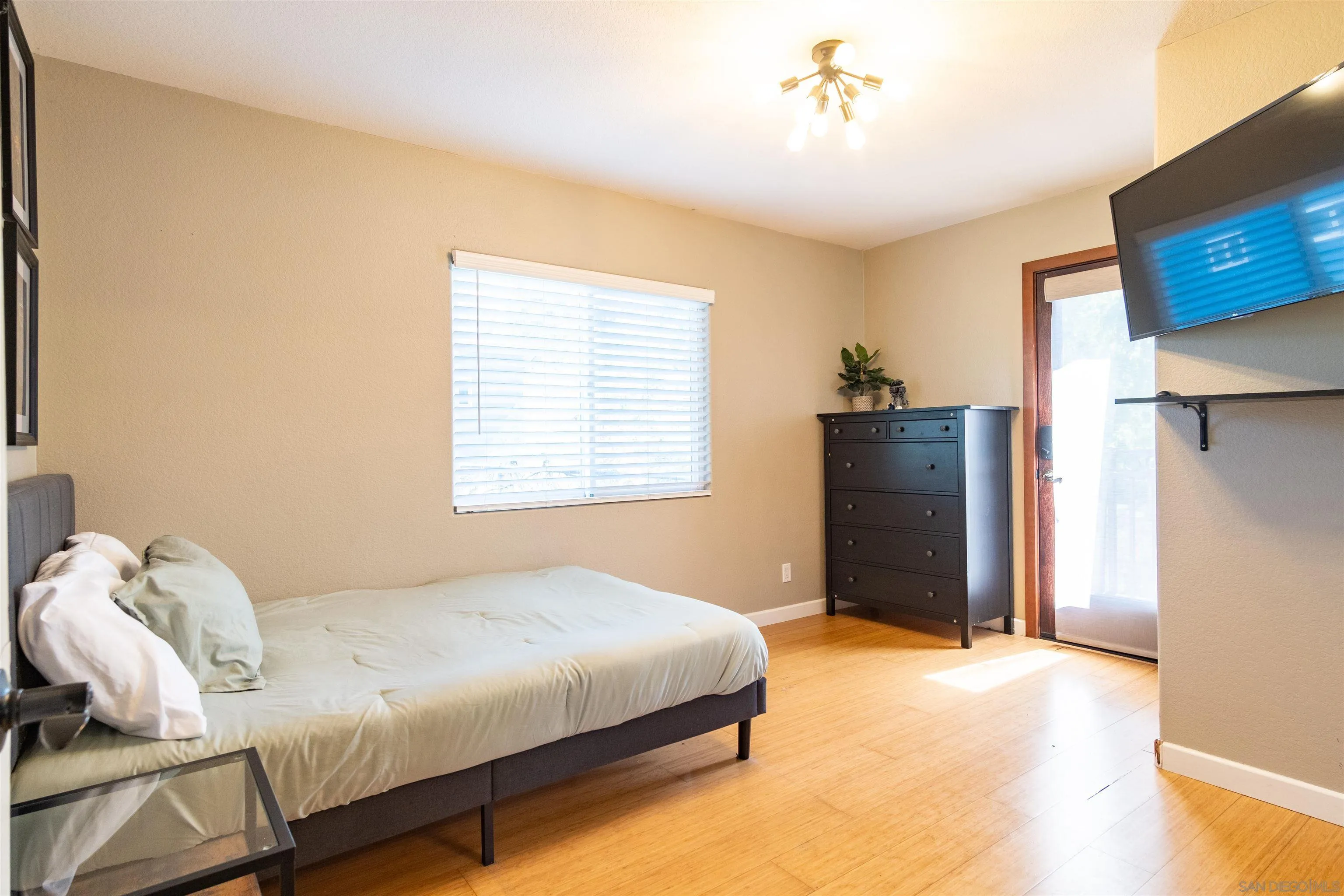 853 Crescent Drive Vista, CA 92084 - Photo 32 of 70 a bedroom with a bed and a television