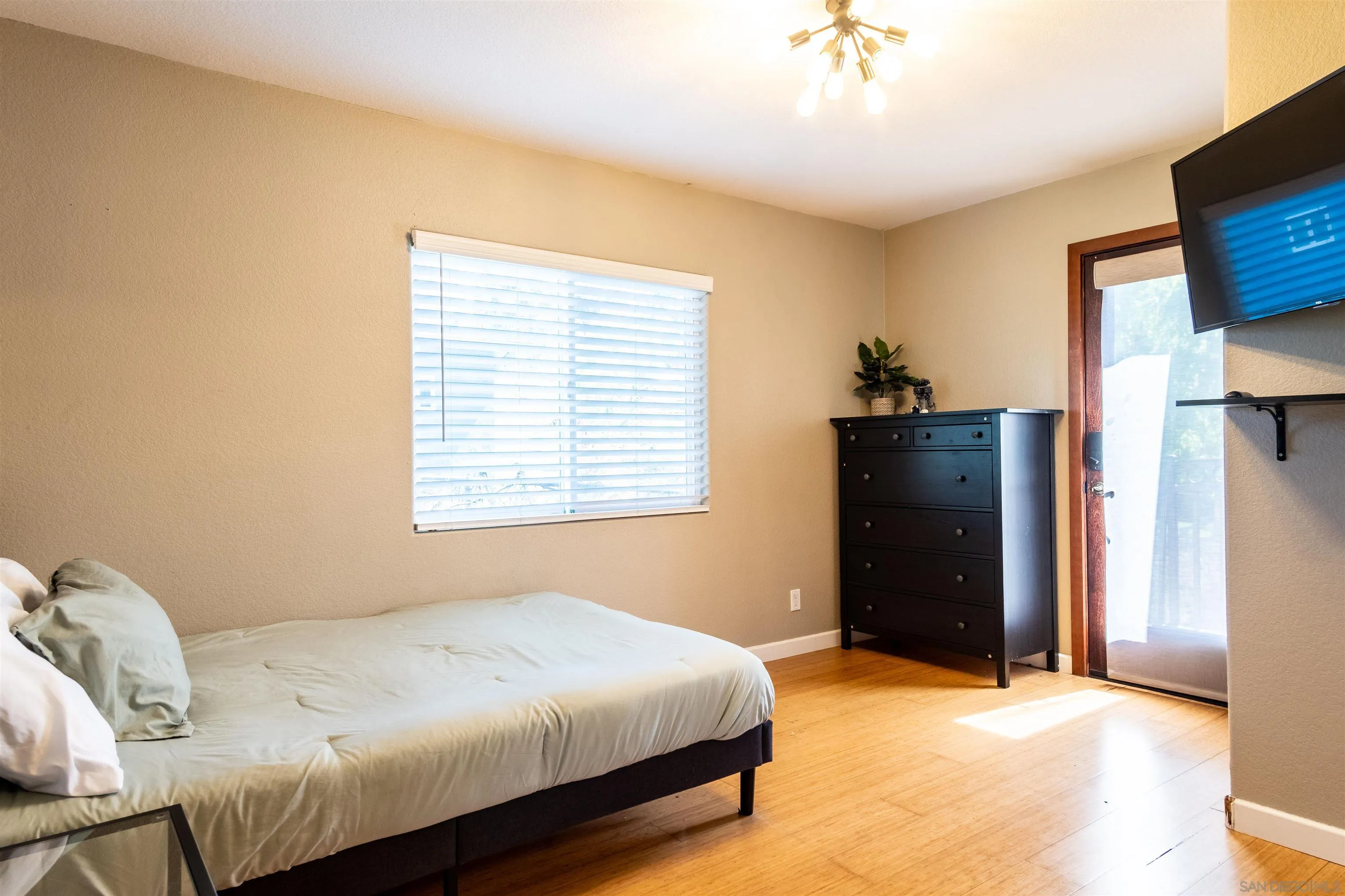 853 Crescent Drive Vista, CA 92084 - Photo 33 of 70 a bedroom with a bed and a flat tv screen