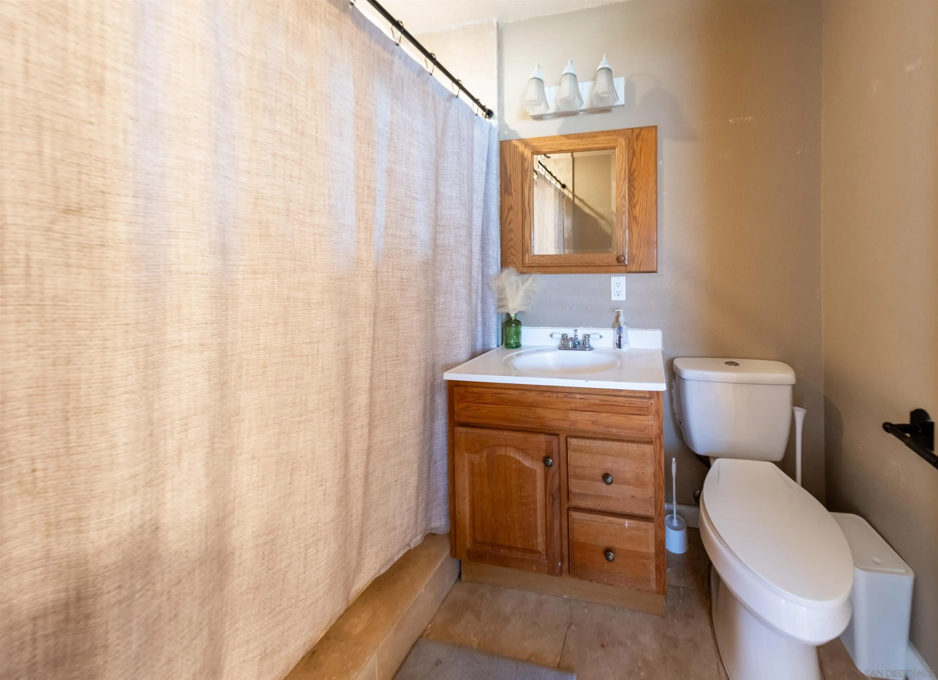 853 Crescent Drive Vista, CA 92084 - Photo 50 of 70 a bathroom with a toilet sink and mirror