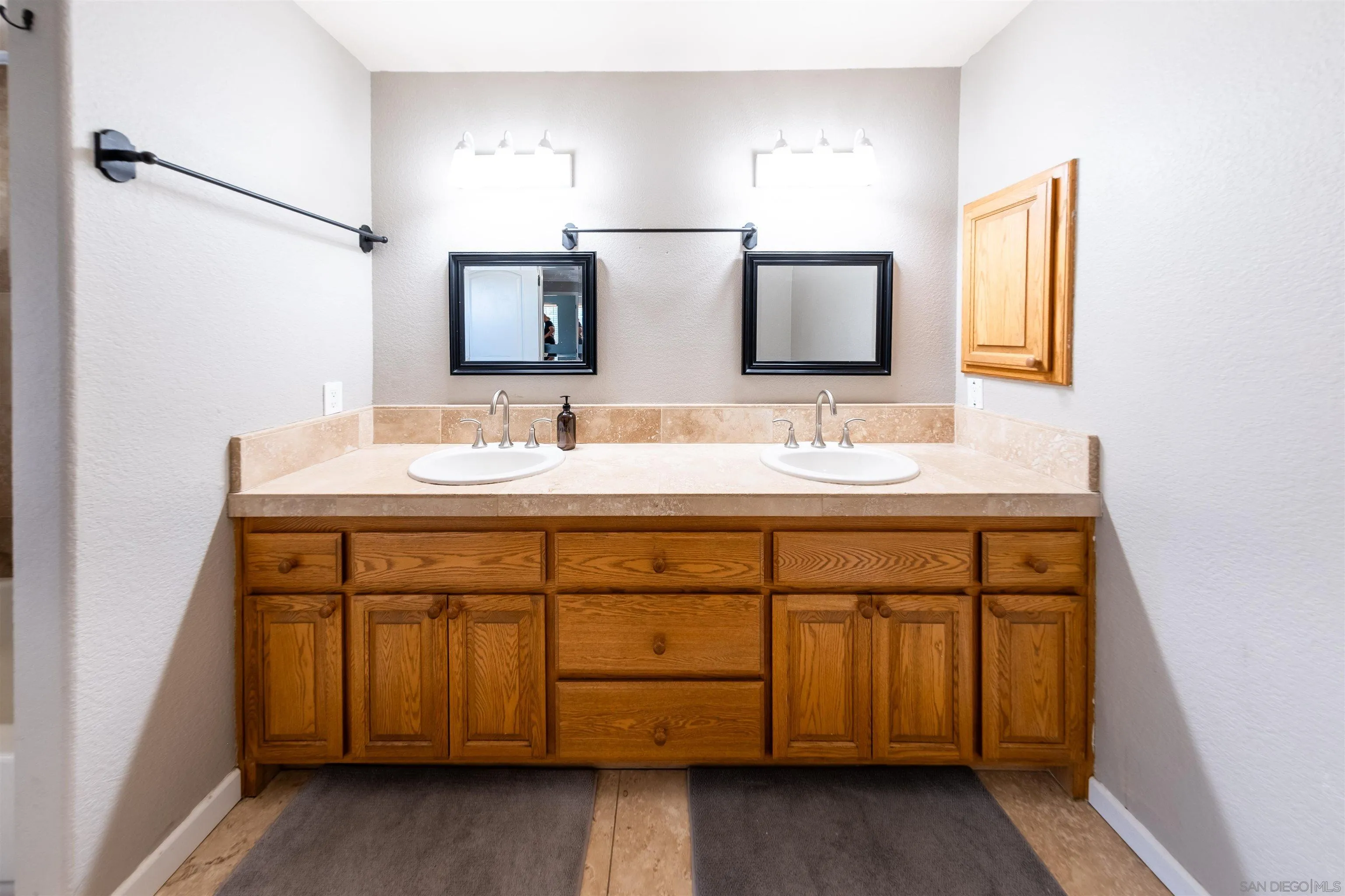 853 Crescent Drive Vista, CA 92084 - Photo 51 of 70 a bathroom with a double vanity sink and a mirror