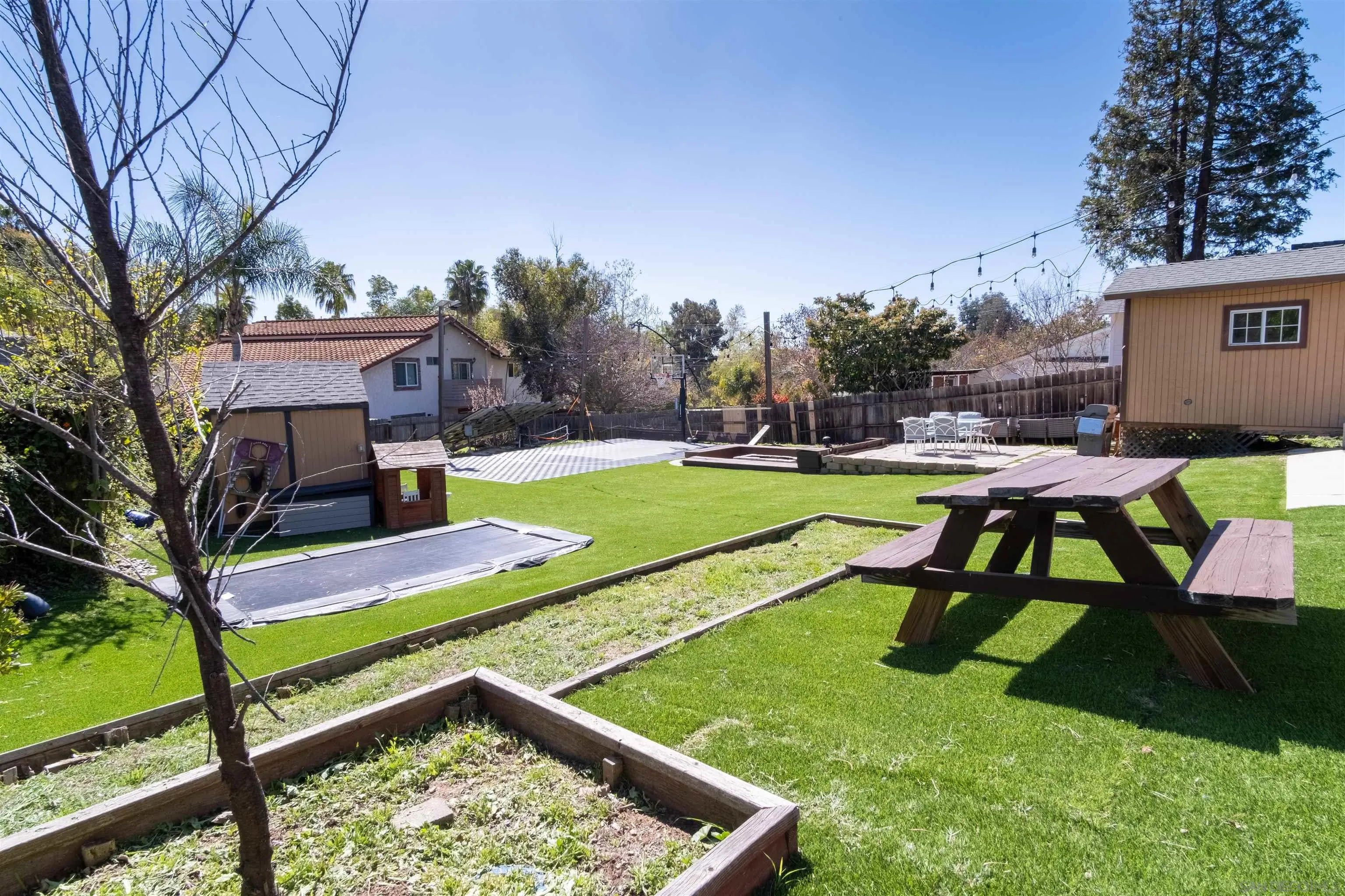 853 Crescent Drive Vista, CA 92084 - Photo 59 of 70 a view of a backyard with wooden fence and a bench