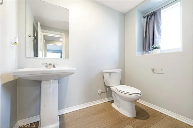 a bathroom with a sink toilet and a mirror