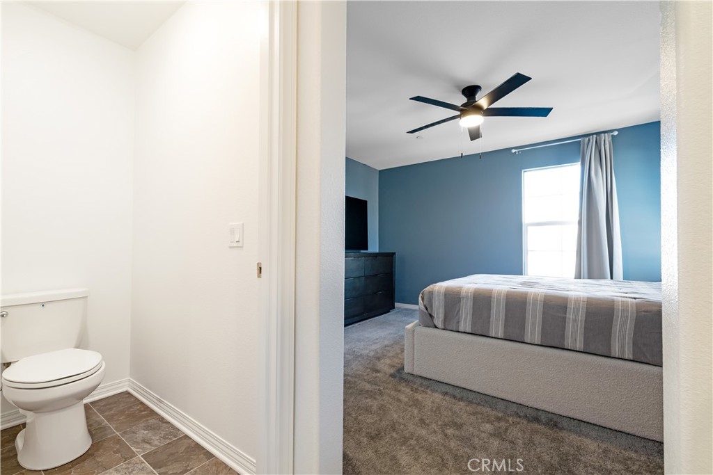 2498 Gunner Ridge Way Rialto, CA 92377 - Photo 15 of 31 a bedroom with a bed and a window