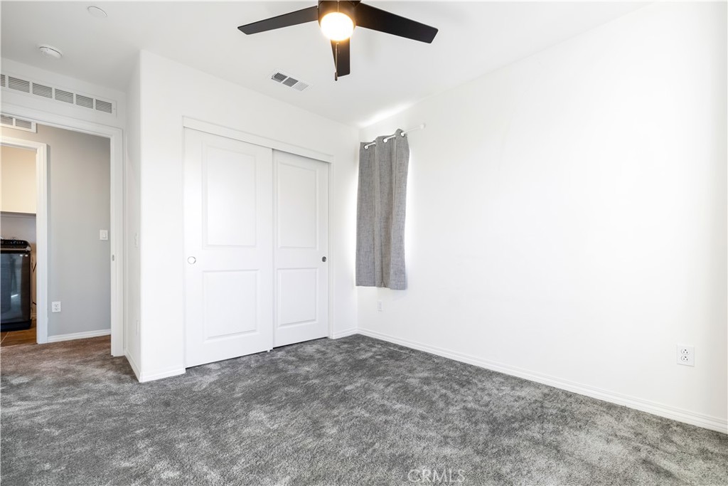 2498 Gunner Ridge Way Rialto, CA 92377 - Photo 19 of 31 an empty room with a ceiling fan and a window