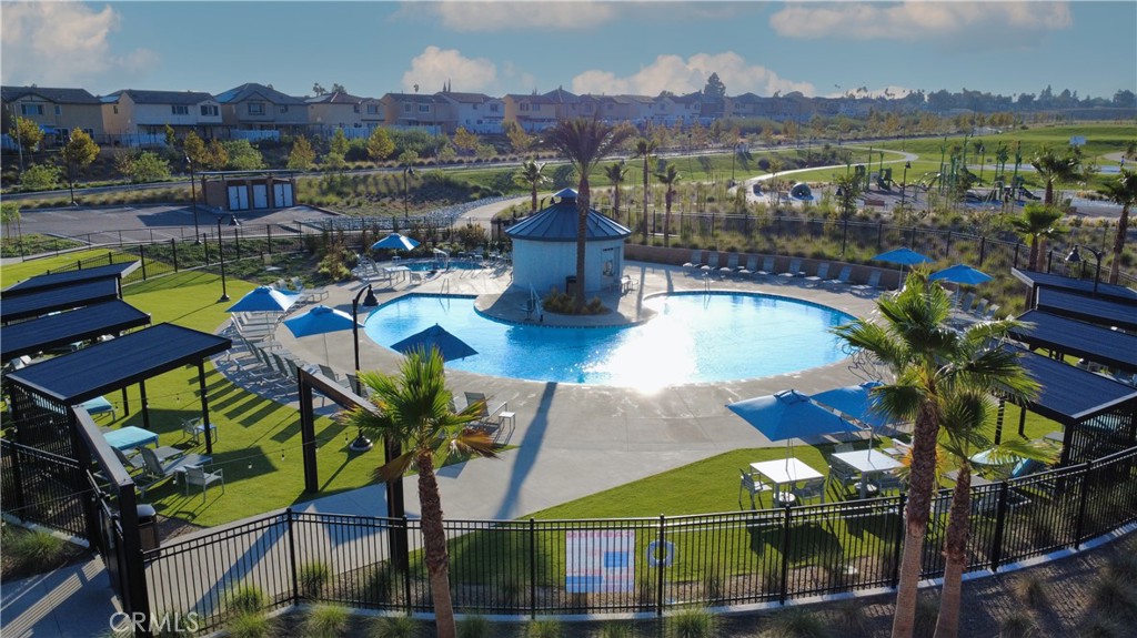 2498 Gunner Ridge Way Rialto, CA 92377 - Photo 23 of 31 a view of swimming pool with outdoor seating and city view