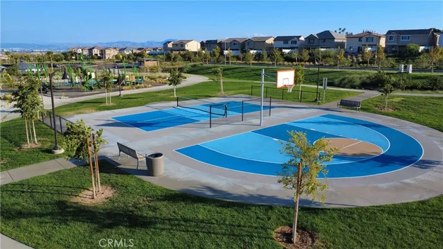 a view of a swimming pool with a table and chairs under an umbrella