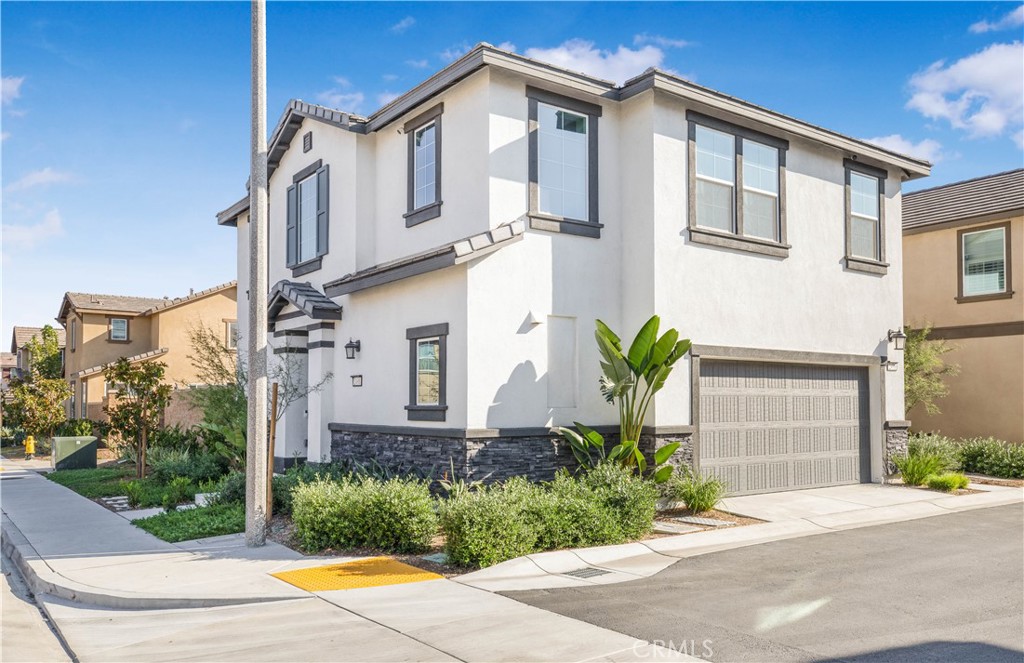 2498 Gunner Ridge Way Rialto, CA 92377 - Photo 4 of 31 a front view of a house with garden