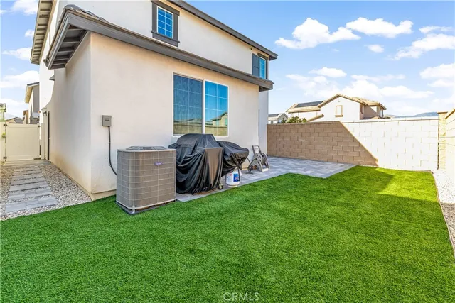 a view of backyard of house with wooden fence