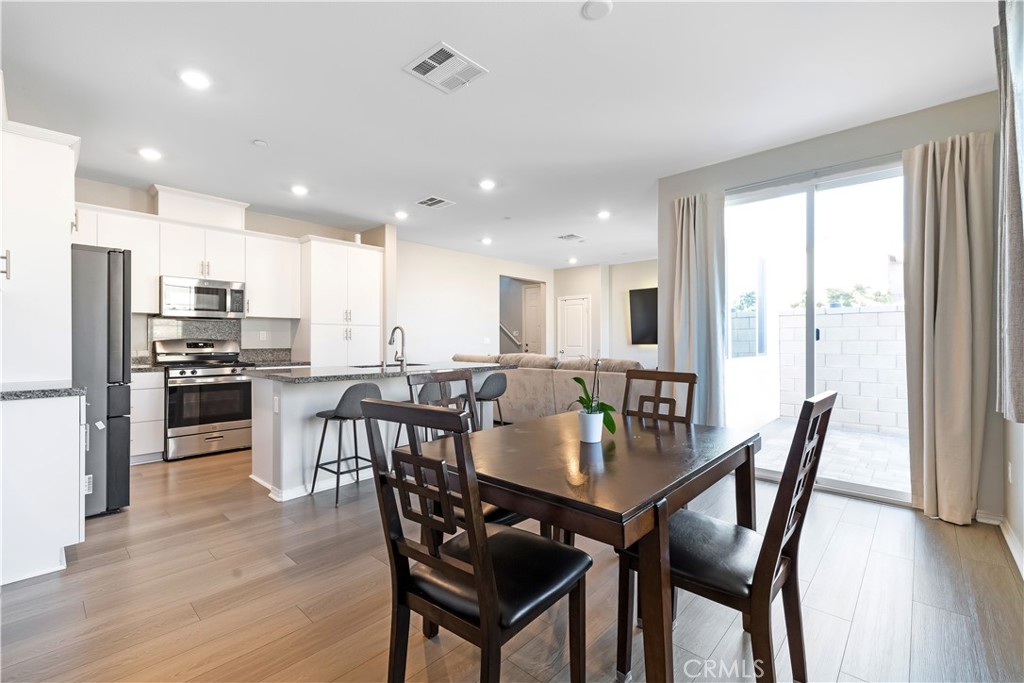 2498 Gunner Ridge Way Rialto, CA 92377 - Photo 7 of 31 a view of a dining room and livingroom kitchen island with furniture