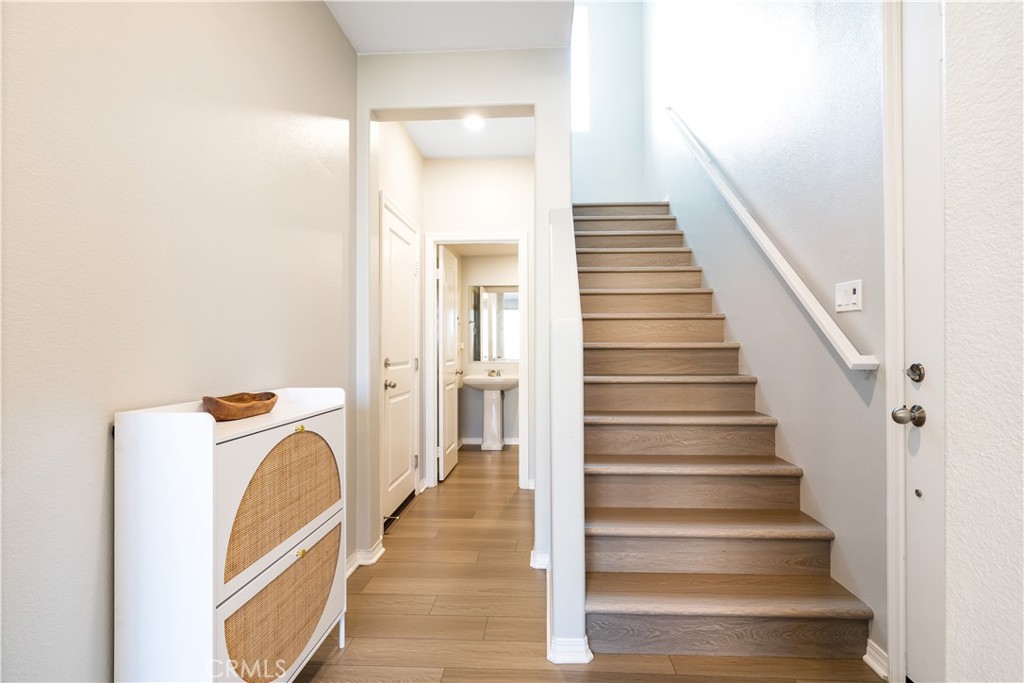 2498 Gunner Ridge Way Rialto, CA 92377 - Photo 10 of 31 a view of a hallway with wooden floor and entryway