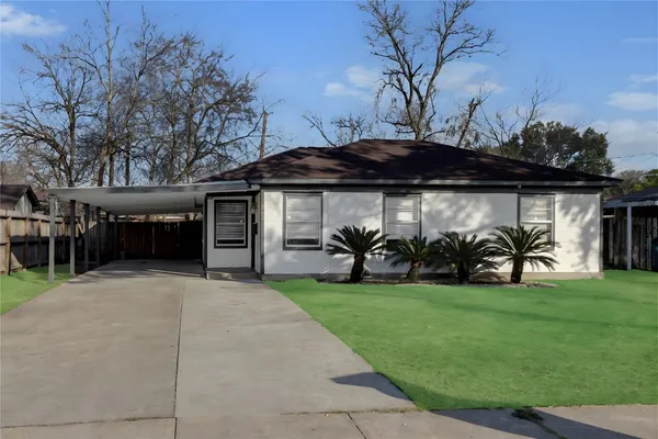 a view of a backyard with table and chairs under an umbrella