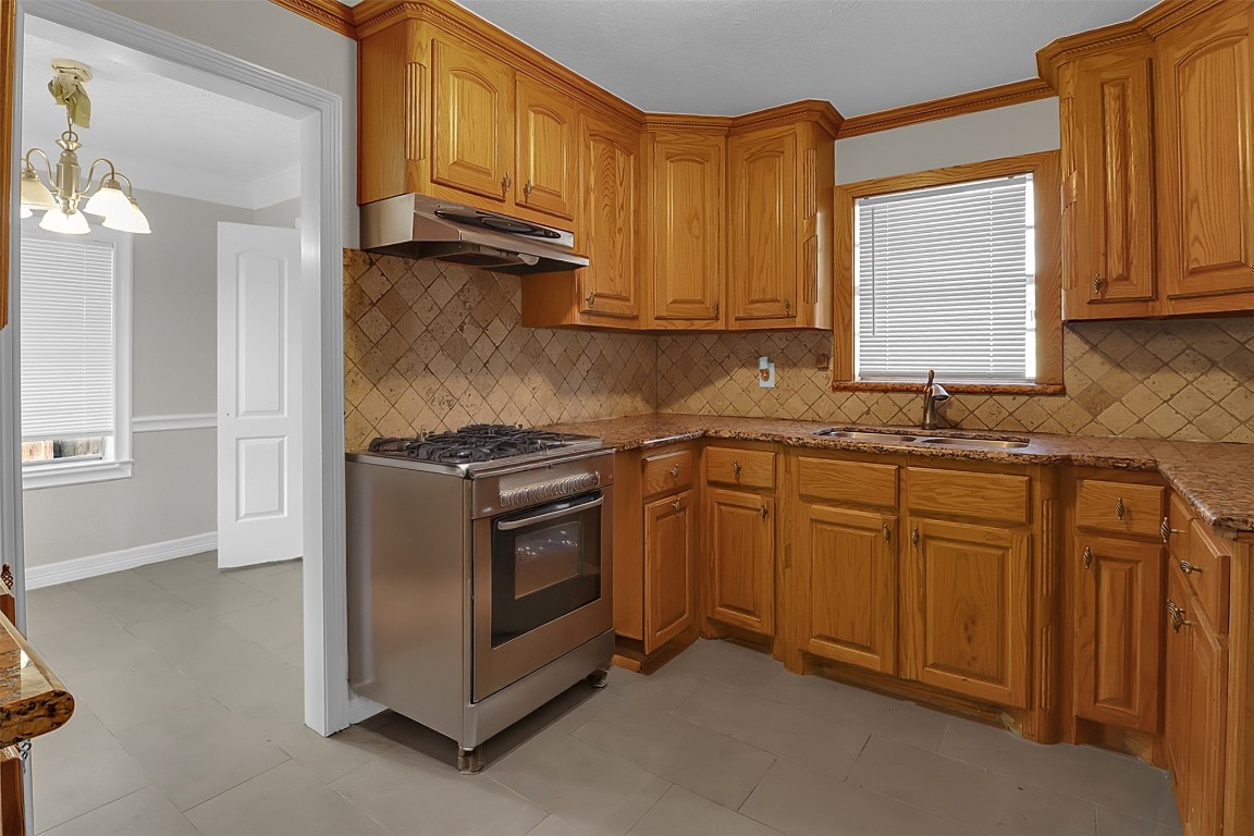 505 Garrett Street Pasadena, TX 77506 - Photo 5 of 14 a kitchen with stainless steel appliances granite countertop a stove a sink and a microwave