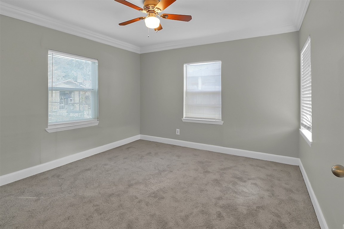 505 Garrett Street Pasadena, TX 77506 - Photo 9 of 14 an empty room with windows and fan
