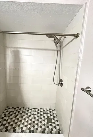a view of a livingroom with wooden floor and a ceiling fan