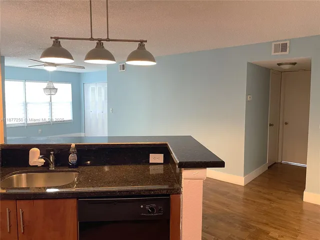a kitchen with wooden cabinets and a stove top oven