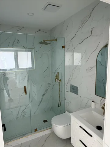 a bathroom with a sink toilet and shower