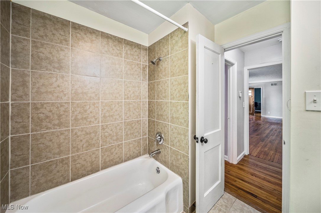 1796 Lander Road Mayfield Heights, OH 44124 - Photo 23 of 39 Bathroom featuring tiled shower / bath and hardwood / wood-style flooring