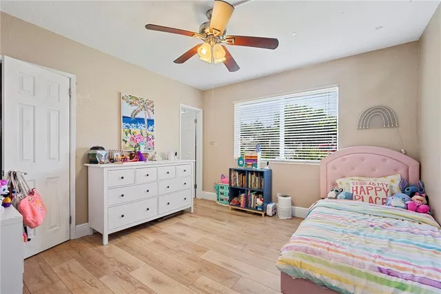 a bedroom with a bed dresser and a window