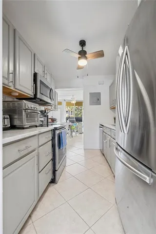 a kitchen with stainless steel appliances granite countertop a refrigerator and a stove top oven