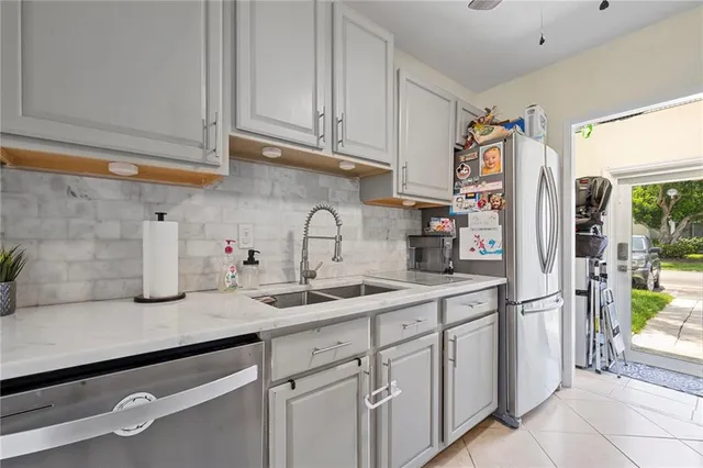 a kitchen with stainless steel appliances granite countertop a refrigerator and a sink