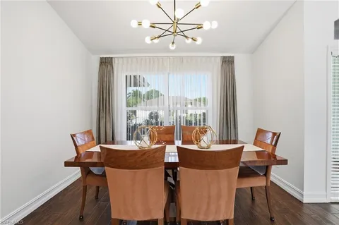 a dining room with furniture and wooden floor