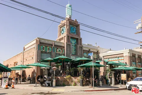 a view of a brick wall with a building in the background