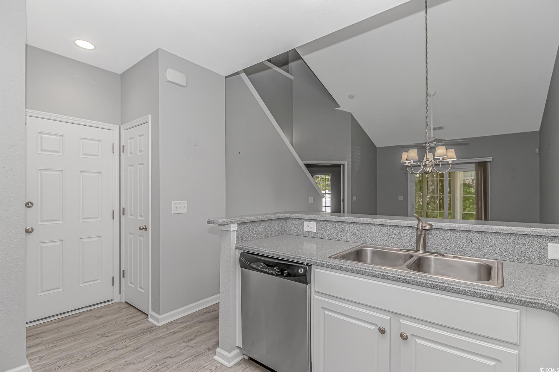 751 Painted Bunting Drive, Unit E Murrells Inlet, SC 29576 - Photo 15 of 40 Kitchen featuring dishwasher, a sink, light wood-type flooring, white cabinetry, and a chandelier