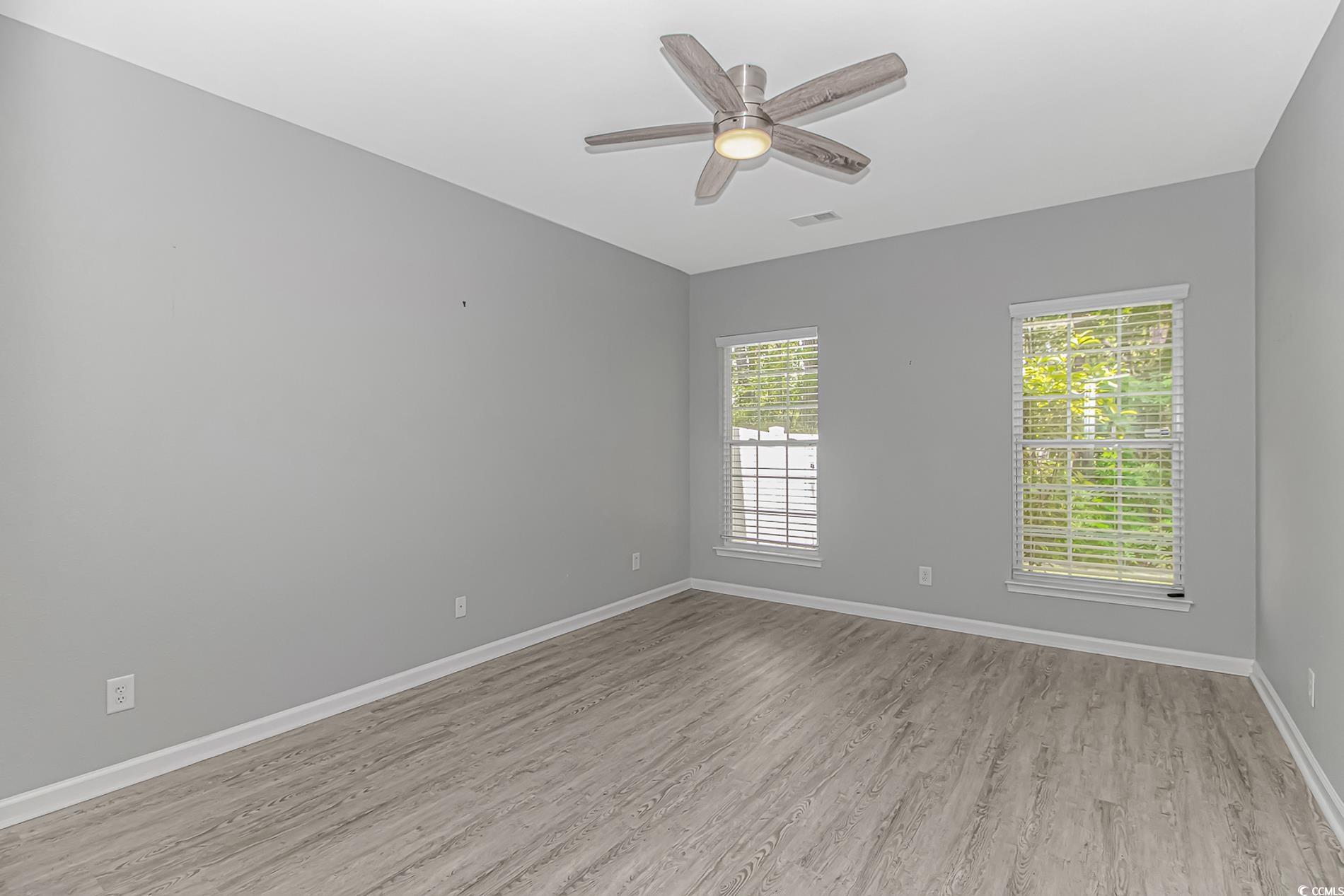 751 Painted Bunting Drive, Unit E Murrells Inlet, SC 29576 - Photo 20 of 40 Empty room with light wood-style floors, baseboards, and ceiling fan
