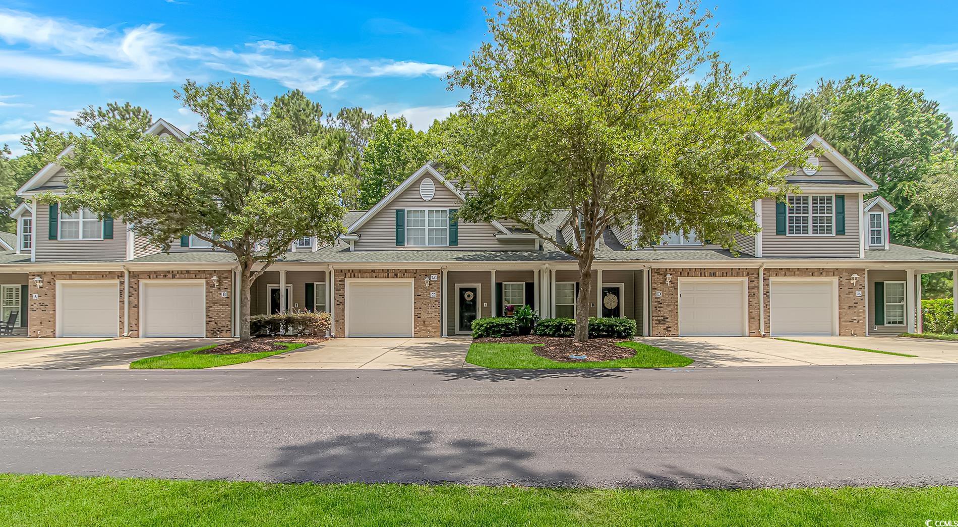 751 Painted Bunting Drive, Unit E Murrells Inlet, SC 29576 - Photo 2 of 40 View of front of property featuring brick siding, a garage, roof with shingles, and a porch