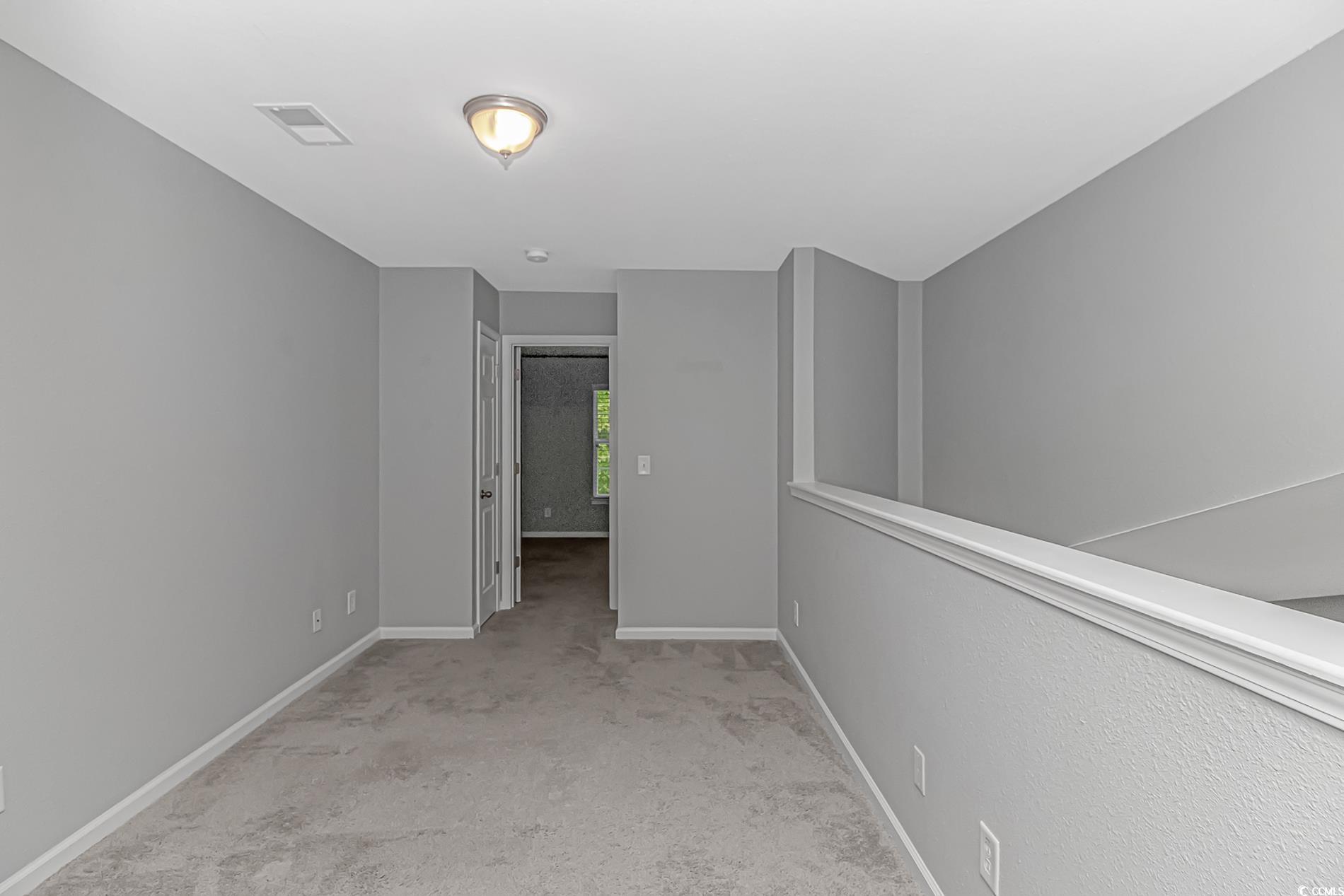 751 Painted Bunting Drive, Unit E Murrells Inlet, SC 29576 - Photo 25 of 40 Carpeted empty room featuring baseboards