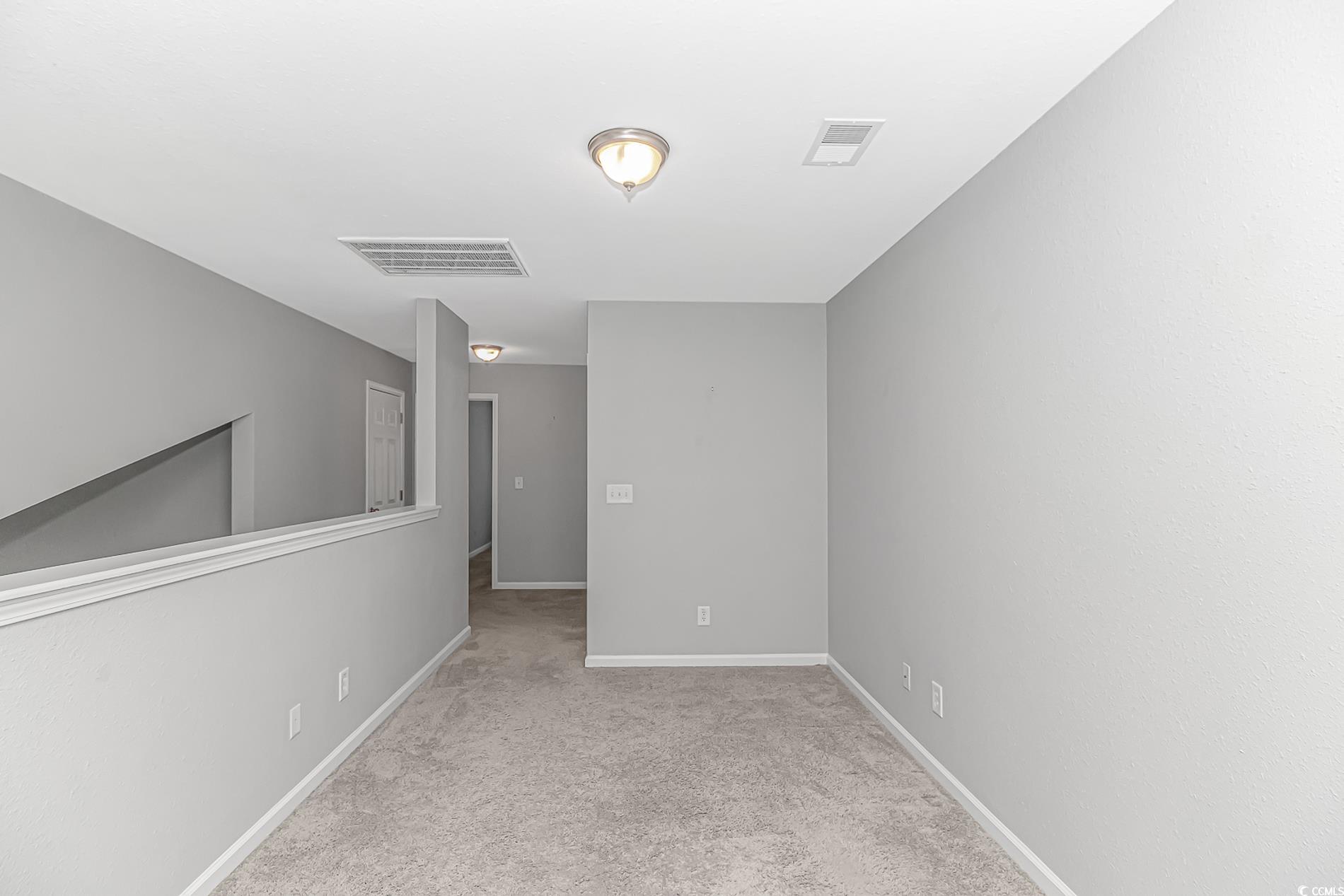 751 Painted Bunting Drive, Unit E Murrells Inlet, SC 29576 - Photo 26 of 40 Empty room with carpet floors and baseboards