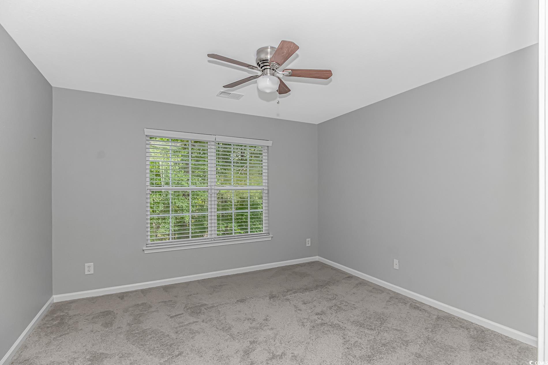 751 Painted Bunting Drive, Unit E Murrells Inlet, SC 29576 - Photo 27 of 40 Carpeted spare room featuring a ceiling fan and baseboards