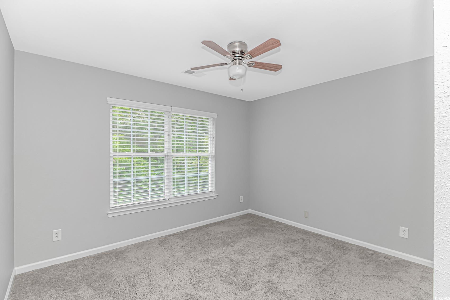 751 Painted Bunting Drive, Unit E Murrells Inlet, SC 29576 - Photo 31 of 40 Carpeted empty room featuring ceiling fan and baseboards